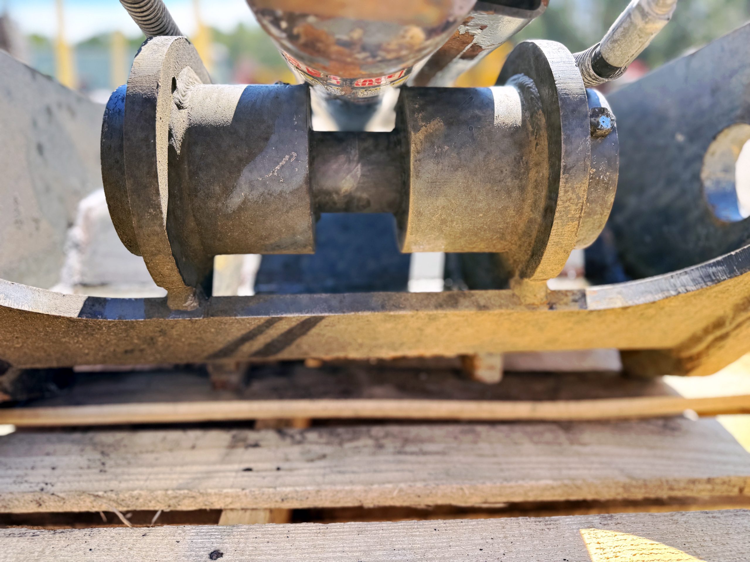 Used heavy-duty TAG Manufacturing 64-inch hydraulic main-pin excavator thumb, featuring 80mm pin bores, 20-inch ear width, and serrated dual tines for 20-ton class machines.