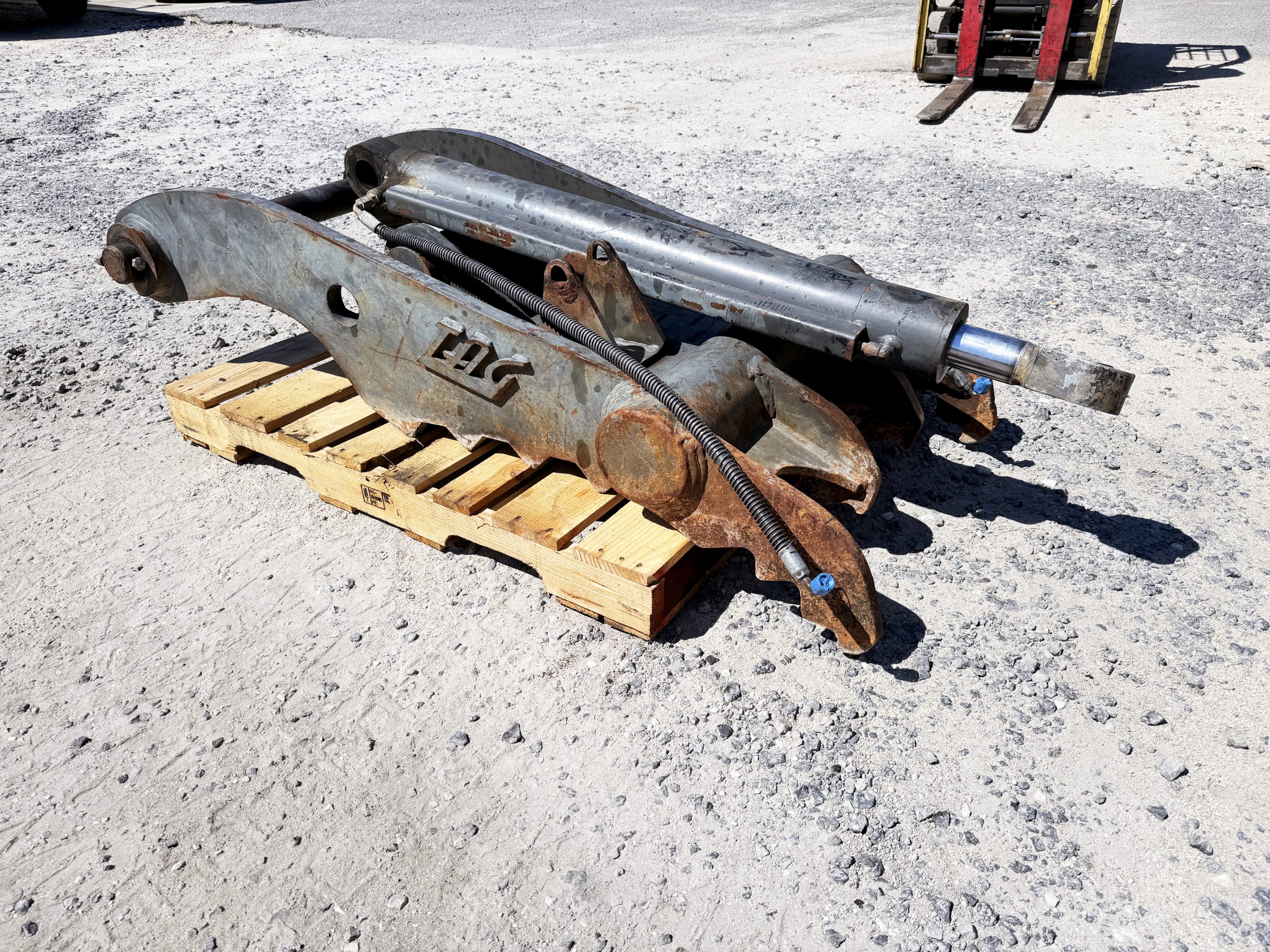 Used heavy-duty TAG Manufacturing 64-inch hydraulic main-pin excavator thumb, featuring 80mm pin bores, 20-inch ear width, and serrated dual tines for 20-ton class machines.
